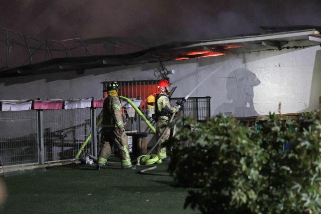 Firefighters work to stop a fire caused by debris after a rocket interception in a residential area near Tel Aviv, on March 5, 2026. The latest round of Iranian missile fire caused explosions across the city and damage in central Israel, but there were no reported casualties and residents have been cleared to leave shelters. Israeli police said it was "currently handling scenes involving fallen projectiles in central Israel," adding that "damage has been caused," but also reporting no injuries.on March 5, 2026. (Photo by AHMAD GHARABLI / AFP)