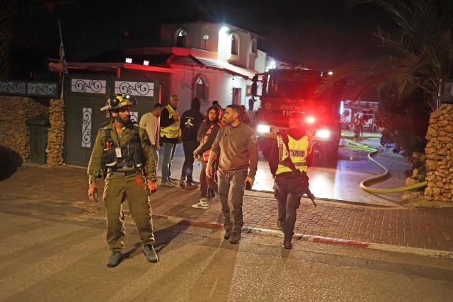 Firefighters work to stop a fire caused by debris after a rocket interception in a residential area near Tel Aviv, on March 5, 2026. The latest round of Iranian missile fire caused explosions across the city and damage in central Israel, but there were no reported casualties and residents have been cleared to leave shelters. Israeli police said it was "currently handling scenes involving fallen projectiles in central Israel," adding that "damage has been caused," but also reporting no injuries.on March 5, 2026. (Photo by AHMAD GHARABLI / AFP)