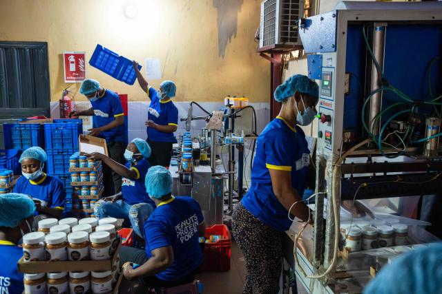 Workers at the Nutzy factory demonstrate the packaging process for the new Mothers of Chibok product line in Lagos on February 27, 2026. Nine women from Chibok are collaborating with Zenfix Nigeria, a company that sells peanuts and nut products, and Arjena Foods, producer of the Nutzy peanut butter brand, which is very popular in Nigeria. 
This partnership was supported by Joel Kachi Benson, director of the documentary "Mothers of Chibok," released in theaters last week, which chronicles the lives of these mothers. 
Before the creation of Mothers of Chibok, their harvests were sold unprocessed to middlemen in the village, generating meager and unpredictable incomes. Today, they work has better value, they obtain a stable income, and reach a wider audience. 
These women's peanut production increased from 15 100kg bags to 27 bags between 2024 and 2025.
For Ajrena Foods and Zenfix Nigeria, the initiative is part of a social and economic reconstruction project that could inspire other mothers whose children have also been abducted by Boko Haram, other jihadist groups, or criminal gangs. (Photo by TOYIN ADEDOKUN / AFP)