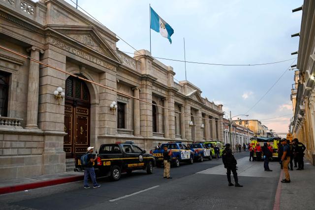 Members of the Public Prosecutor's Office and police officers are seen during the collection of evidence after masked protesters who were arrested with pyrotechnic bombs outside the National Congress, where a session for the election of two magistrates for the Constitutional Court was held in Guatemala City on March 5, 2026. (Photo by JOHAN ORDONEZ / AFP)