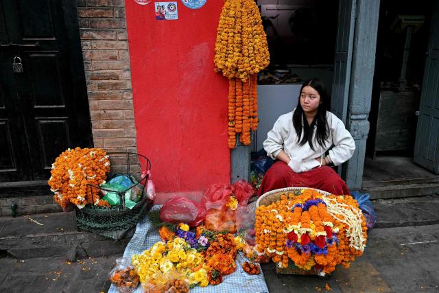 A flower-vendor waits for customers along a street in Kathmandu on March 6, 2026 a day after Nepal's Parliamentary election. Counting was underway in Nepal on March 6, after a high-stakes parliamentary election that could reshape the country's leadership following 2025 protests that toppled the government. (Photo by TAUSEEF MUSTAFA / AFP)
