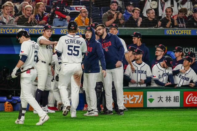 Czech Republic's Martin Cervenk (#55) celebrates with his teammates after scoring during the World Baseball Classic (WBC) Pool C first round game between Czech Republic and Australia at the Tokyo Dome in Tokyo on March 6, 2026. (Photo by Yuichi YAMAZAKI / AFP)
