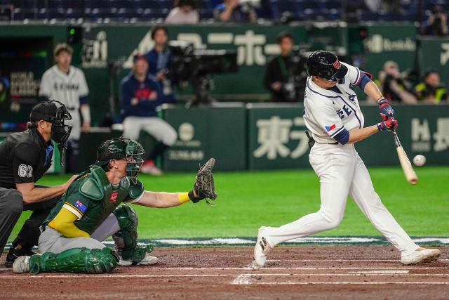 Czech Republic's Vojtech Mensik hits a sacrifice fly during the World Baseball Classic (WBC) Pool C first round game between Czech Republic and Australia at the Tokyo Dome in Tokyo on March 6, 2026. (Photo by Yuichi YAMAZAKI / AFP)