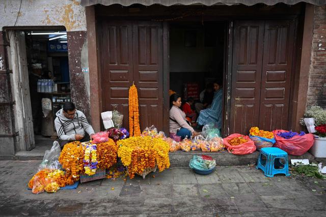 Flower vendors wait for customers along a street of Durbar Square in Kathmandu on March 6, 2026 a day after Nepal's Parliamentary election. Counting was underway in Nepal on March 6, after a high-stakes parliamentary election that could reshape the country's leadership following 2025 protests that toppled the government. (Photo by Prakash MATHEMA / AFP)