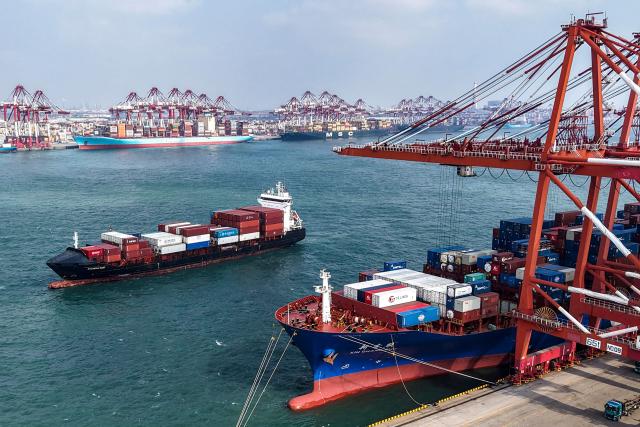 A container ship sail into the port in Qingdao, in China’s eastern Shandong province on March 6, 2026. (Photo by CN-STR / AFP) / China OUT
