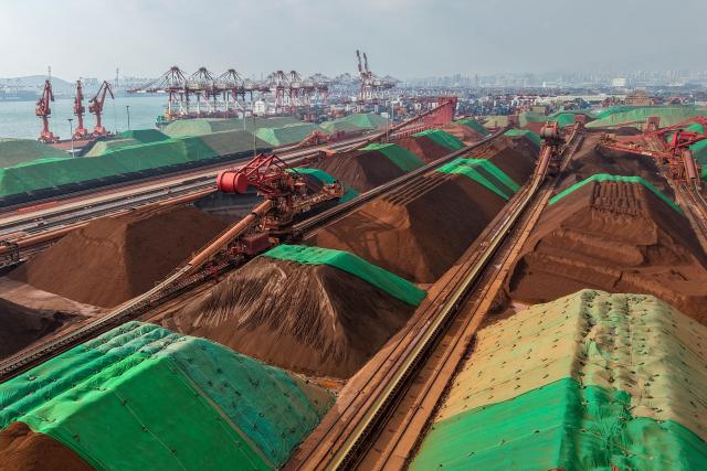 This photo shows an aerial view of an iron ore terminal at the Qingdao port, in China’s eastern Shandong province on March 6, 2026. (Photo by CN-STR / AFP) / China OUT