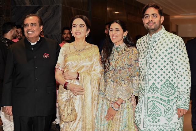(L-R) Chairman and managing director of Reliance Industries, Mukesh Ambani, his wife Nita Ambani, daughter-in-law Shloka Mehta and son Akash Ambani pose for photographs during the wedding ceremony of Arjun Tendulkar, son of former Indian cricketer Sachin Tendulkar, in Mumbai on March 5, 2026. (Photo by Sujit JAISWAL / AFP)