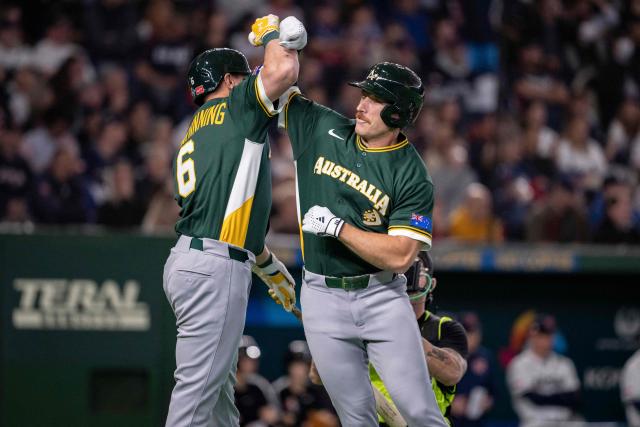 Australia's Alex Hall (R) celebrates with Robbie Glendinning after hitting a solo homerun during the World Baseball Classic (WBC) Pool C first round game between Czech Republic and Australia at the Tokyo Dome in Tokyo on March 6, 2026. (Photo by Yuichi YAMAZAKI / AFP)