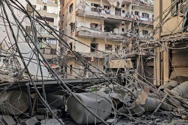 In this frame grab from AFPTV video footage taken on March 6, 2026, a road strewn with rubble and debris is seen after heavy overnight Israeli strikes on Beirut's southern suburbs. The raging Iran war, which has spread across the Middle East and beyond, entered its seventh day on March 6 after Israeli forces announced a "next phase" in the conflict and bombed Beirut's southern suburbs. (Photo by AFPTV / AFP)