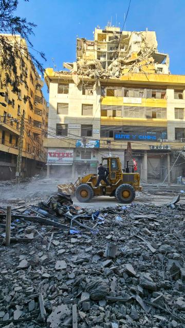 Workers use a bulldozer to clear debris from a street at the site of overnight Israeli airstrikes in the southern suburbs of Beirut on March 6, 2026. Heavy attacks were reported in Tehran on March 6 after Israel said it was hitting "regime infrastructure" in a "new phase" of the war it launched with the United States against Iran. As the conflict entered its seventh day, its regional repercussions continued -- with Qatar saying it intercepted a drone targeting a US base, and Lebanon reporting the death toll from Israeli strikes had risen to 123. (Photo by AFP)