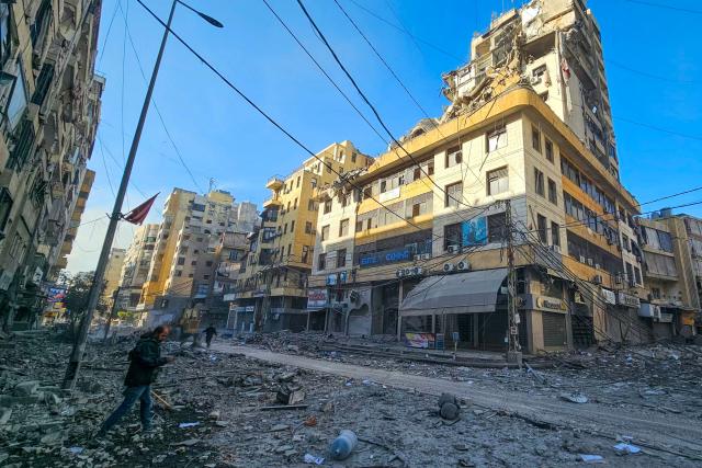 A man walks along a street at the site of overnight Israeli airstrikes in the southern suburbs of Beirut on March 6, 2026. Heavy attacks were reported in Tehran on March 6 after Israel said it was hitting "regime infrastructure" in a "new phase" of the war it launched with the United States against Iran. As the conflict entered its seventh day, its regional repercussions continued -- with Qatar saying it intercepted a drone targeting a US base, and Lebanon reporting the death toll from Israeli strikes had risen to 123. (Photo by AFP)