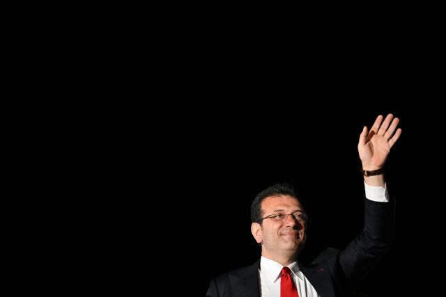 (FILES) Istanbul's newly elected mayor Ekrem Imamoglu waves as opposition Republican People's Party (CHP) supporters celebrate outside the main municipality building following municipal elections across Turkey, in Istanbul on March 31, 2024. Turkish opposition challenger Ekrem Imamoglu goes on trial March 9, 2026 on corruption charges, making it increasingly unlikely he'll contest the next election, analysts say. But his party insists it remains viable despite mounting legal pressure. (Photo by YASIN AKGUL / AFP)