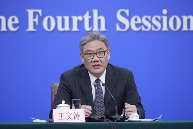 China's Minister of Commerce Wang Wentao attends a new conference on economy for the fourth session of the 14th National People's Congress (NPC) in Beijing on March 6, 2026. (Photo by Iori SAGISAWA / POOL / AFP)