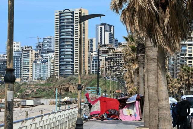 Makeshift shelters used by residents who fled Israeli airstrikes in Beirut's southern suburbs are seen along the corniche waterfront in the Lebanese capital on March 6, 2026. Fresh strikes rocked Iran and Lebanon on March 6, as Israel vowed to escalate to a new phase in the Middle East war that has spiralled rapidly throughout the region and beyond. (Photo by Joseph EID / AFP)