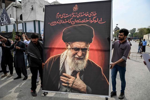 Shia Muslims hold a portrait of Iran's slain supreme leader Ayatollah Ali Khamenei during an anti US-Israel protest in Islamabad on March 6, 2026. The United States and Israel started striking Iran on February 28, killing Iran's supreme leader and top military leaders, and prompting authorities to retaliate with strikes on Israel and across the Gulf. (Photo by Aamir QURESHI / AFP)