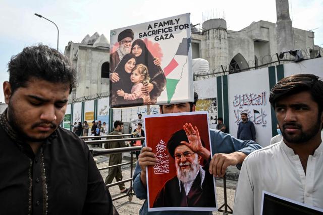 A Shia Muslim holds portraits of Iran's slain supreme leader Ayatollah Ali Khamenei during an anti US-Israel protest in Islamabad on March 6, 2026. The United States and Israel started striking Iran on February 28, killing Iran's supreme leader and top military leaders, and prompting authorities to retaliate with strikes on Israel and across the Gulf. (Photo by Aamir QURESHI / AFP)