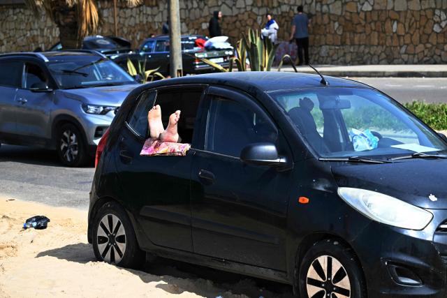 A displaced resident who fled Israeli airstrikes in Beirut's southern suburbs rests in a car along the corniche waterfront in the Lebanese capital on March 6, 2026. Fresh strikes rocked Iran and Lebanon on March 6, as Israel vowed to escalate to a new phase in the Middle East war that has spiralled rapidly throughout the region and beyond. (Photo by Joseph EID / AFP)
