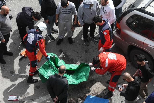 EDITORS NOTE: Graphic content / First aid responders search for human remains in the perimeter of a building targeted by an Israeli airstrike in the southern Lebanese coastal city of Sidon on March 6, 2026. Fresh strikes rocked Iran and Lebanon on March 6, as Israel vowed to escalate to a new phase in the Middle East war that has spiralled rapidly throughout the region and beyond. (Photo by MAHMOUD ZAYYAT / AFP)