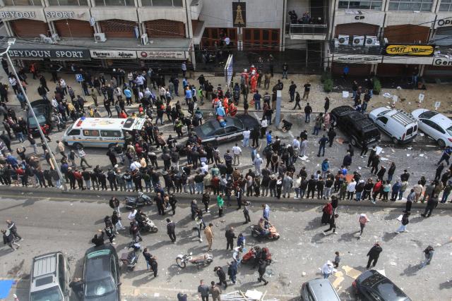 EDITORS NOTE: Graphic content / People watch as first aid responders and security forces work near a building that was targeted by an Israeli airstrike in the southern Lebanese coastal city of Sidon on March 6, 2026. Fresh strikes rocked Iran and Lebanon on March 6, as Israel vowed to escalate to a new phase in the Middle East war that has spiralled rapidly throughout the region and beyond. (Photo by Mahmoud ZAYYAT / AFP)