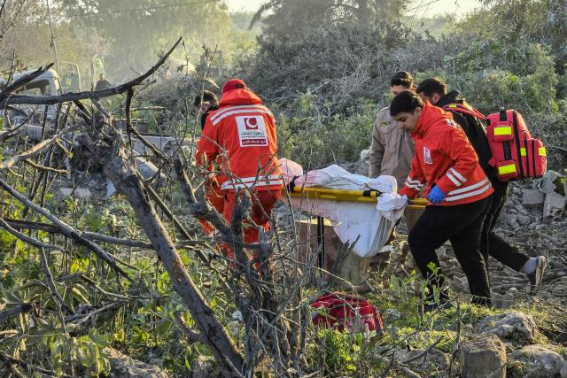 First aid responders evacuate a body from the site of an Israeli airstrike that targeted the southern Lebanese city of Tyre on March 6, 2026. Fresh strikes rocked Iran and Lebanon on March 6, as Israel vowed to escalate to a new phase in the Middle East war that has spiralled rapidly throughout the region and beyond. (Photo by KAWNAT HAJU / AFP)