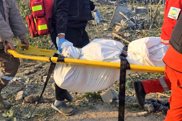First aid responders evacuate a body from the site of an Israeli airstrike that targeted the southern Lebanese city of Tyre on March 6, 2026. Fresh strikes rocked Iran and Lebanon on March 6, as Israel vowed to escalate to a new phase in the Middle East war that has spiralled rapidly throughout the region and beyond. (Photo by KAWNAT HAJU / AFP)