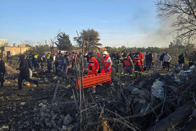 First aid responders rush to the site of an Israeli airstrike that targeted the southern Lebanese city of Tyre on March 6, 2026. Fresh strikes rocked Iran and Lebanon on March 6, as Israel vowed to escalate to a new phase in the Middle East war that has spiralled rapidly throughout the region and beyond. (Photo by KAWNAT HAJU / AFP)