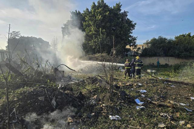 Firefighter douse flames that swept over the site of an Israeli airstrike that targeted the southern Lebanese city of Tyre on March 6, 2026. Fresh strikes rocked Iran and Lebanon on March 6, as Israel vowed to escalate to a new phase in the Middle East war that has spiralled rapidly throughout the region and beyond. (Photo by KAWNAT HAJU / AFP)