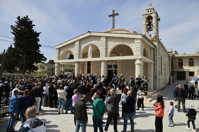 Residents of the southern Lebanese border town of Marjeyoun gather at the town's churchyard to assert their intention not to leave their homes as directed by the Israeli military earlier this week on March 6, 2026. Fresh strikes rocked Iran and Lebanon on March 6, as Israel vowed to escalate to a new phase in the Middle East war that has spiralled rapidly throughout the region and beyond. (Photo by Rabih DAHER / AFP)