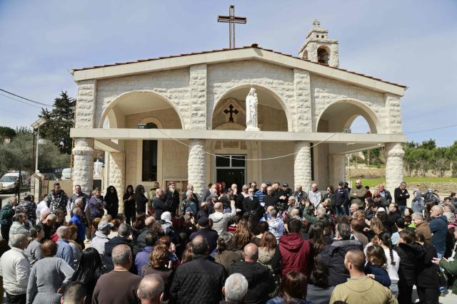 TOPSHOT - Residents of the southern Lebanese border town of Marjeyoun gather at the town's churchyard to assert their intention not to leave their homes as directed by the Israeli military earlier this week on March 6, 2026. Fresh strikes rocked Iran and Lebanon on March 6, as Israel vowed to escalate to a new phase in the Middle East war that has spiralled rapidly throughout the region and beyond. (Photo by Rabih DAHER / AFP)