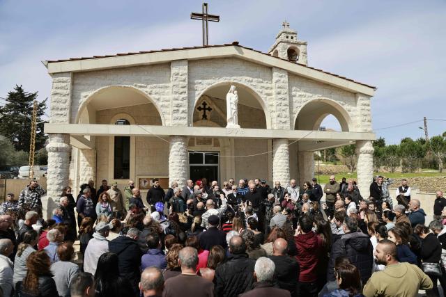Residents of the southern Lebanese border town of Marjeyoun gather at the town's churchyard to assert their intention not to leave their homes as directed by the Israeli military earlier this week on March 6, 2026. Fresh strikes rocked Iran and Lebanon on March 6, as Israel vowed to escalate to a new phase in the Middle East war that has spiralled rapidly throughout the region and beyond. (Photo by Rabih DAHER / AFP)