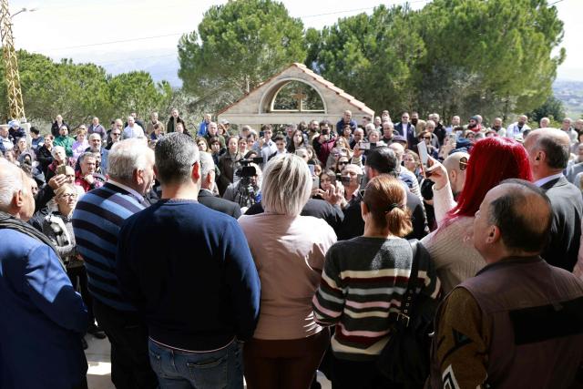 Residents of the southern Lebanese border town of Marjeyoun gather to listen to thei priest in the town's churchyard to assert their intention not to leave their homes as directed by the Israeli military earlier this week on March 6, 2026. Fresh strikes rocked Iran and Lebanon on March 6, as Israel vowed to escalate to a new phase in the Middle East war that has spiralled rapidly throughout the region and beyond. (Photo by Rabih DAHER / AFP)