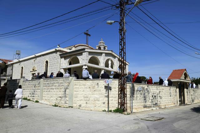Residents of the southern Lebanese border town of Marjeyoun gather in the town's churchyard to assert their intention not to leave their homes as directed by the Israeli military earlier this week on March 6, 2026. Fresh strikes rocked Iran and Lebanon on March 6, as Israel vowed to escalate to a new phase in the Middle East war that has spiralled rapidly throughout the region and beyond. (Photo by Rabih DAHER / AFP)