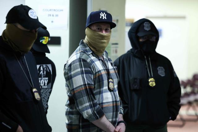 Masked federal agents stand in a hallway at the New York Federal Plaza Immigration Court inside the Jacob K. Javitz Federal Building in New York on March 6, 2026. US President Donald Trump has made deporting undocumented immigrants a key priority for his second term, after successfully campaigning against an alleged "invasion" by criminals. (Photo by CHARLY TRIBALLEAU / AFP)
