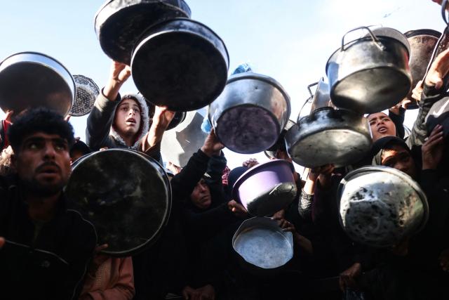 Displaced Palestinians jostle for food at a food bank in Khan Yunis, in the south of the Gaza Strip on March 6, 2026. The majority of Gaza's 2.4 million people have been displaced, often multiple times, by the war that began with Hamas's attack on southern Israel on October 7, 2023. With displaced families living in tented camps, with serious concerns raised over their living conditions. (Photo by Bashar Taleb / AFP)