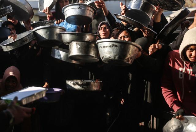 Displaced Palestinians jostle for food at a food bank in Khan Yunis, in the south of the Gaza Strip on March 6, 2026. The majority of Gaza's 2.4 million people have been displaced, often multiple times, by the war that began with Hamas's attack on southern Israel on October 7, 2023. With displaced families living in tented camps, with serious concerns raised over their living conditions. (Photo by Bashar Taleb / AFP)