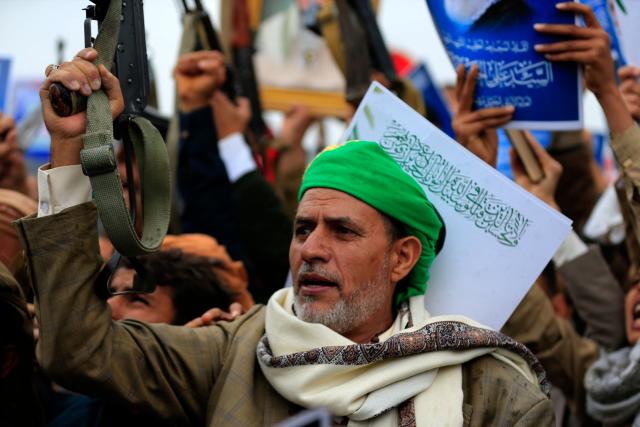 Houthi supporters brandish rifles and chant slogans during a rally in solidarity with Iran and Lebanon, amid the US-Israeli conflict with Iran, in the Yemeni capital Sanaa on March 6, 2026. The US president on March 6, demanded Iran's "unconditional surrender" as the only acceptable outcome to end hostilities, while promising to help rebuild the country's economy if Tehran complied. (Photo by Mohammed HUWAIS / AFP)