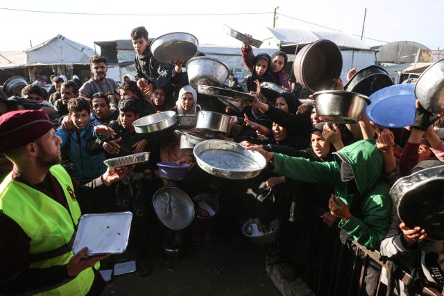 Displaced Palestinians jostle for food at a food bank in Khan Yunis, in the south of the Gaza Strip on March 6, 2026. The majority of Gaza's 2.4 million people have been displaced, often multiple times, by the war that began with Hamas's attack on southern Israel on October 7, 2023. With displaced families living in tented camps, with serious concerns raised over their living conditions. (Photo by Bashar Taleb / AFP)