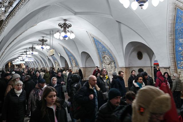 Commuters walk inside Taganskaya Metro Station in Moscow, on March 6, 2026. (Photo by Hector RETAMAL / AFP)