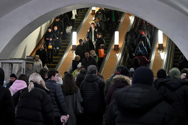 Commuters walk inside Taganskaya Metro Station in Moscow, on March 6, 2026. (Photo by Hector RETAMAL / AFP)