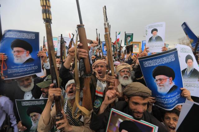 Houthi supporters brandish rifles and chant slogans during a rally in solidarity with Iran and Lebanon, amid the US-Israeli conflict with Iran, in the Yemeni capital Sanaa on March 6, 2026. The US president on March 6, demanded Iran's "unconditional surrender" as the only acceptable outcome to end hostilities, while promising to help rebuild the country's economy if Tehran complied. (Photo by Mohammed HUWAIS / AFP)