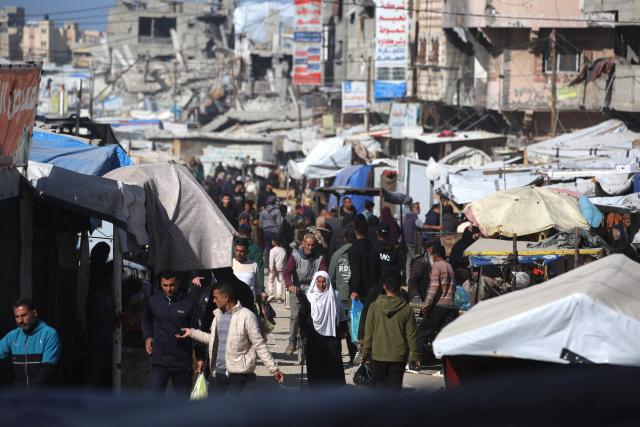 Displaced Palestinians who lost their homes and businesses during Israeli military bombardment of the Gaza Strip, shop in a market set-up close to destroyed buildings in Khan Yunis, in the south of the Gaza Strip on March 6, 2026. The majority of Gaza's 2.4 million people have been displaced, often multiple times, by the war that began with Hamas's attack on southern Israel on October 7, 2023. With displaced families living in tented camps, with serious concerns raised over their living conditions. (Photo by Bashar Taleb / AFP)