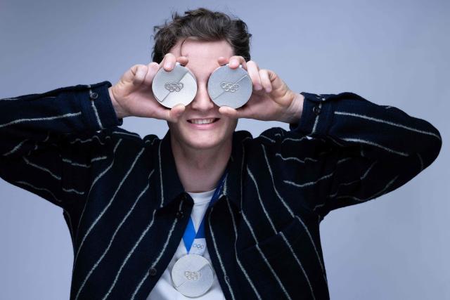 French cross-country skier Mathis Desloges poses with the 3 silver medals he won at the Milan Cortina Winter Olympics during a photo session in Paris on March 6, 2026. (Photo by Joel Saget / AFP)