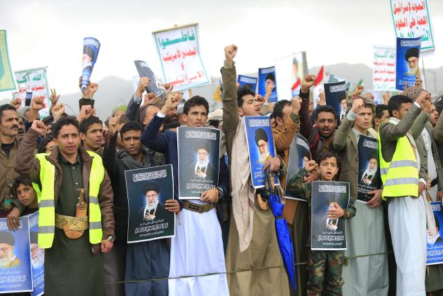 Houthi supporters shout slogans and hold portraits of Iran's slain supreme leader Ayatollah Ali Khamenei during a rally in solidarity with Iran and Lebanon, amid the US-Israeli conflict with Iran, in the Yemeni capital Sanaa on March 6, 2026. The US president on March 6, demanded Iran's "unconditional surrender" as the only acceptable outcome to end hostilities, while promising to help rebuild the country's economy if Tehran complied. (Photo by Mohammed HUWAIS / AFP)