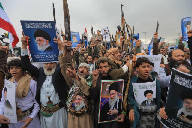 Houthi supporters brandish rifles and hold portraits of Iran's slain supreme leader Ayatollah Ali Khamenei during a rally in solidarity with Iran and Lebanon, amid the US-Israeli conflict with Iran, in the Yemeni capital Sanaa on March 6, 2026. The US president on March 6, demanded Iran's "unconditional surrender" as the only acceptable outcome to end hostilities, while promising to help rebuild the country's economy if Tehran complied. (Photo by Mohammed HUWAIS / AFP)