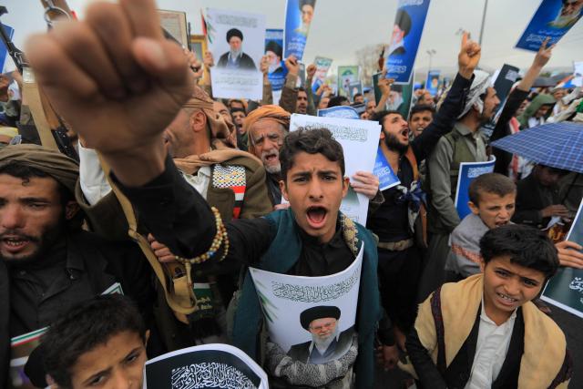 Houthi supporters shout slogans and hold portraits of Iran's slain supreme leader Ayatollah Ali Khamenei during a rally in solidarity with Iran and Lebanon, amid the US-Israeli conflict with Iran, in the Yemeni capital Sanaa on March 6, 2026. The US president on March 6, demanded Iran's "unconditional surrender" as the only acceptable outcome to end hostilities, while promising to help rebuild the country's economy if Tehran complied. (Photo by Mohammed HUWAIS / AFP)