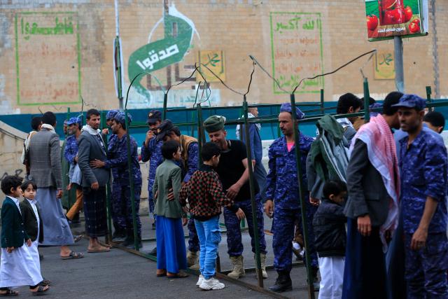 Security personnel frisk Houthi supporters at a check-point during a rally in solidarity with Iran and Lebanon, amid the US-Israeli conflict with Iran, in the Yemeni capital Sanaa on March 6, 2026. The US president on March 6, demanded Iran's "unconditional surrender" as the only acceptable outcome to end hostilities, while promising to help rebuild the country's economy if Tehran complied. (Photo by Mohammed HUWAIS / AFP)