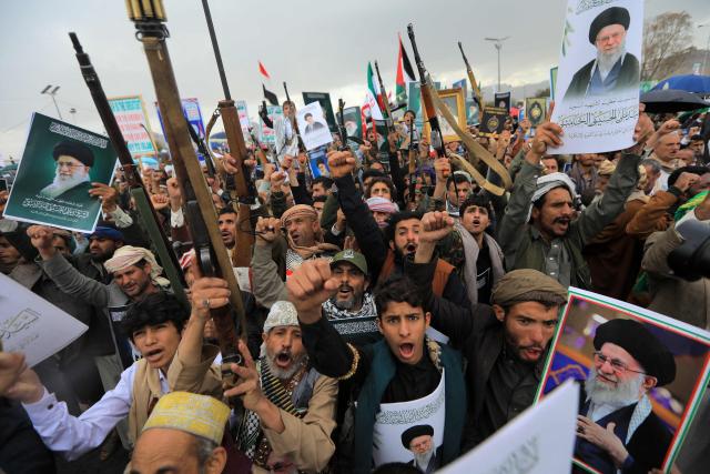 Houthi supporters brandish rifles and hold portraits of Iran's slain supreme leader Ayatollah Ali Khamenei during a rally in solidarity with Iran and Lebanon, amid the US-Israeli conflict with Iran, in the Yemeni capital Sanaa on March 6, 2026. The US president on March 6, demanded Iran's "unconditional surrender" as the only acceptable outcome to end hostilities, while promising to help rebuild the country's economy if Tehran complied. (Photo by Mohammed HUWAIS / AFP)