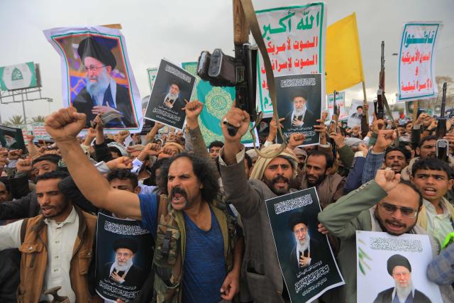 Houthi supporters brandish rifles and hold portraits of Iran's slain supreme leader Ayatollah Ali Khamenei during a rally in solidarity with Iran and Lebanon, amid the US-Israeli conflict with Iran, in the Yemeni capital Sanaa on March 6, 2026. The US president on March 6, demanded Iran's "unconditional surrender" as the only acceptable outcome to end hostilities, while promising to help rebuild the country's economy if Tehran complied. (Photo by Mohammed HUWAIS / AFP)