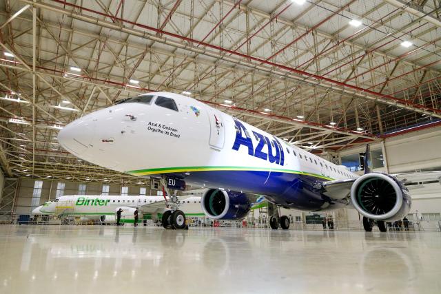 (FILES) View of the Embraer E2-190 aircraft during its christening at the Embraer headquarters in Sao Jose dos Campos, Sao Paulo, Brazil, taken on April 26, 2024. Brazilian aircraft manufacturer Embraer said on March 6, 2026 it had achieved its highest ever revenues in 2025, but US tariffs cut deeply into its profits. The company paid $80 million in tariffs to the United States, a major client for commercial and executive aircraft, and net profit fell 45 percent compared to 2024. (Photo by Miguel SCHINCARIOL / AFP)