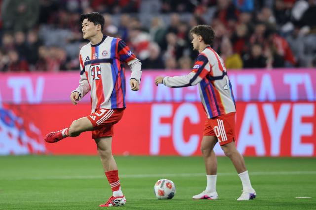 Bayern Munich's South Korean defender #03 Kim Min-Jae warm and Bayern Munich's German midfielder #20 Tom Bischof warm up prior to the German first division Bundesliga football match between FC Bayern Munich and Borussia Moenchengladbach in Munich, southern Germany, on March 6, 2026. (Photo by Alexandra BEIER / AFP) / DFL REGULATIONS PROHIBIT ANY USE OF PHOTOGRAPHS AS IMAGE SEQUENCES AND/OR QUASI-VIDEO